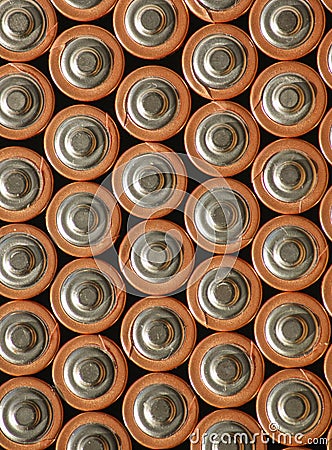 Copper Top Batteries grouped together to form a background of positive tops. Stock Photo