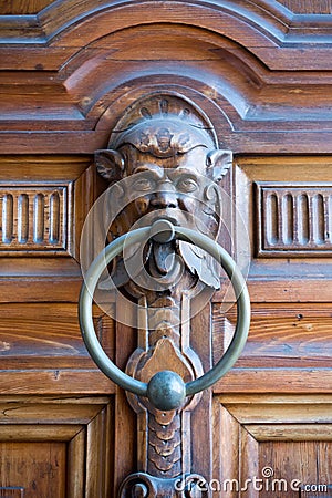 Vertical View of an Old Clapper With Human Fantasy Faces on a De Stock Photo