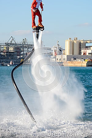 Vertical View of Santa Claus on Flyboard on Blur Background Editorial Stock Photo