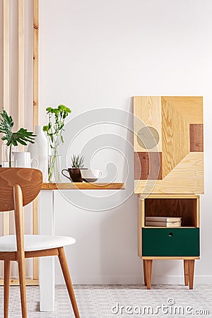 Trendy white and wood dining room design in stylish apartment Stock Photo