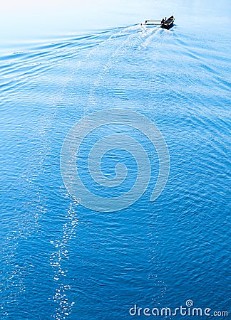 Vertical vivid boat in ocean with water trace Stock Photo