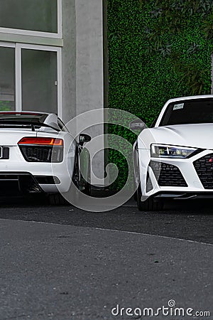 Vertical of a white Audi R8 duo front and rear view outdoors house background Editorial Stock Photo