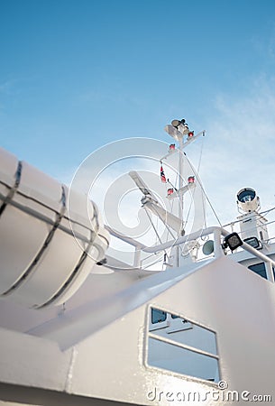 Vertical of a white interior of a boat and a Norway flag against a blue sky Stock Photo
