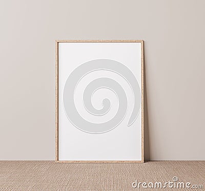 Vertical wooden frame mock up. Wooden frame poster on beige floor with beige wall background. Stock Photo