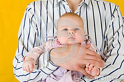 Very amusing child at father hands. Stock Photo