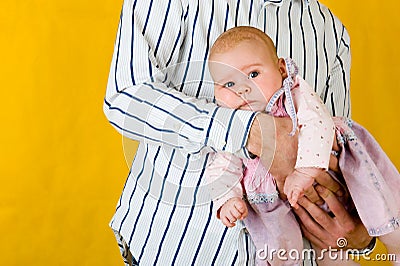 Very amusing child at father hands. Stock Photo