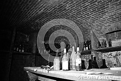 Very ancient bottles of wine lies in retro dark cellar Stock Photo