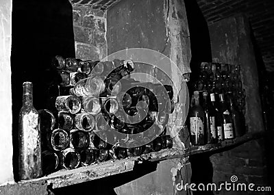 Very ancient bottles of wine lies in retro dark cellar Stock Photo