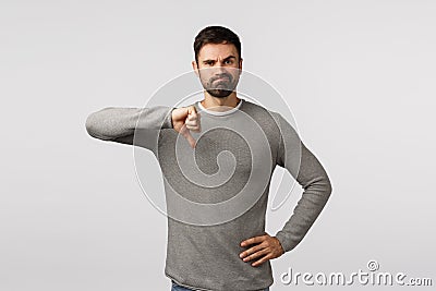 Very bad, dont approve. Skeptical and judgemental serious bearded male entrepreneur left unamused watching awful Stock Photo