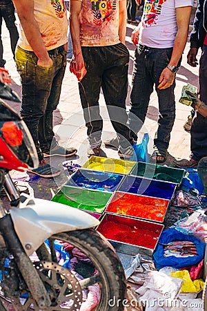 Very bright multicolored paint powders in bags and a small spoon. paints for the holiday of Holi Editorial Stock Photo