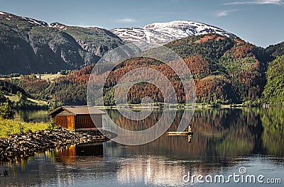 Very calm lake with a fisherman`s cottage Stock Photo