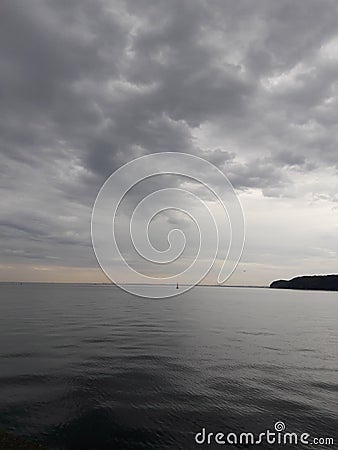 Very calm sea and the evenings clouds Stock Photo