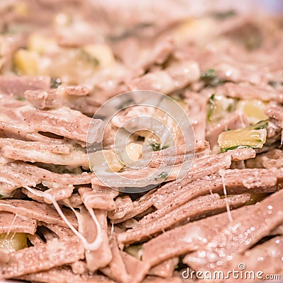 Very close up of the succulent and typical Italian dish Pizzoccheri in a white plate on a table. Typical dish from Valtellina, Stock Photo