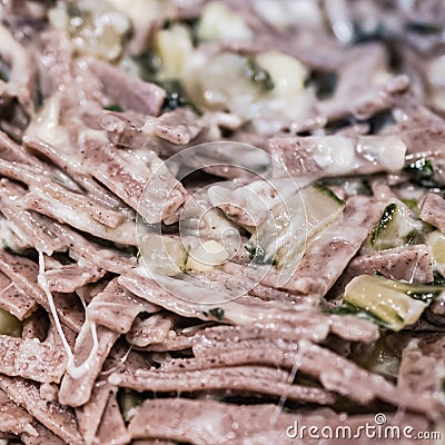 Very close up of the succulent and typical Italian dish Pizzoccheri in a white plate on a table. Typical dish from Valtellina, Stock Photo