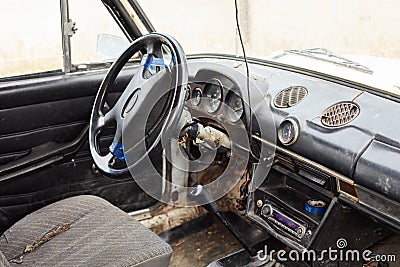 The very damaged interior of an old car from the 1980s Stock Photo