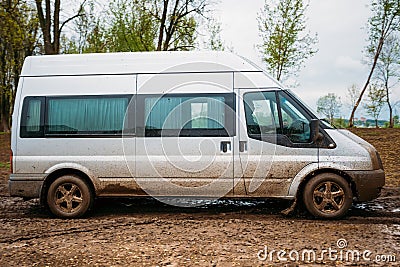 Very Dirty Car Minivan Stalled In The Mud Stock Photo