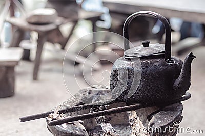 Very dirty teapot on an unfired stove Stock Photo