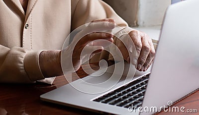 Very elderly woman happily holding a laptop Stock Photo