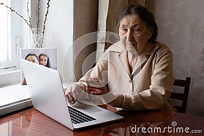 Very elderly woman happily holding a laptop Editorial Stock Photo