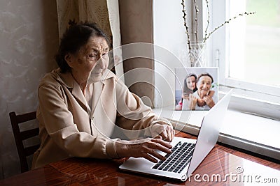 Very elderly woman happily holding a laptop Editorial Stock Photo