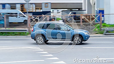 Very fast dangerous driving car on road. Blue Nissan Terrano (Dacia Duster) moves fast on the highway. Side view shot Editorial Stock Photo