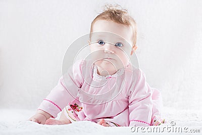 Very funny baby girl in a pink dress Stock Photo