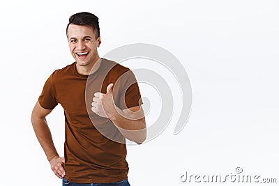 Very good choice, awesome. Handsome smiling, happy adult man in brown t-shirt, laughing satisfied, pleased with great Stock Photo