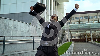 Very happy mulatto office employee shouting joyfully, career promotion success Stock Photo