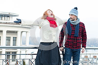 Screaming red hair woman and guy looking to her. Very happy woman crying on the bridge and surprised man. Stock Photo