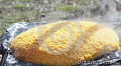 Very large cauldron cooking food during campfire, big pots on fire preparing during food festival Stock Photo