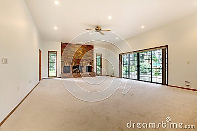 Very large empty living room with brick fireplace. Stock Photo