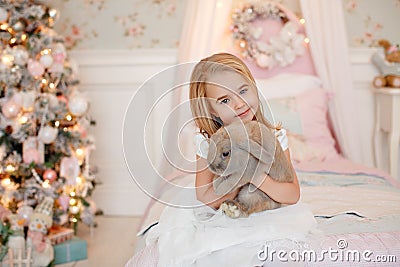 Very nice charming little girl blonde in white dress laughs and Stock Photo