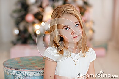 Very nice charming little girl blonde in white dress lying on th Stock Photo