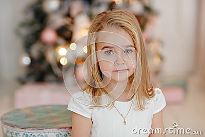 Very nice charming little girl blonde in white dress lying on th Stock Photo