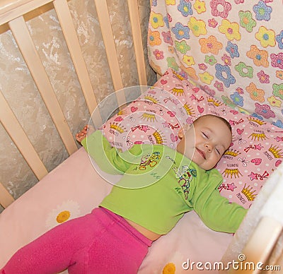 Very nice sweet baby sleeping in crib Stock Photo