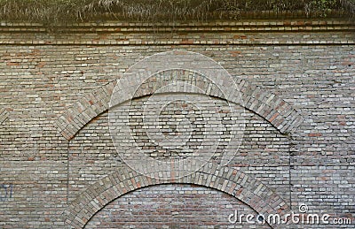 Very old brick stone wall of castle or fortress of 18th century. Full frame wall with obsolete dirty and cracked bricks Stock Photo