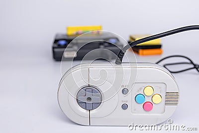 Very old console on a white background. The controller in the foreground Stock Photo