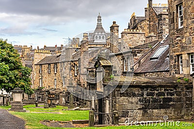 Very old graves located next to dwellings in Greyfriars Cemetery in Edinburgh, Scotland. Stock Photo