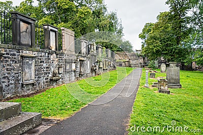 Very old graves located next to dwellings in Greyfriars Cemetery in Edinburgh, Scotland. Stock Photo