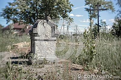 Very old cracked gray stone tombstone on a sunny day Stock Photo