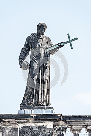 Very old roof statute of high ranked priest with a cross and human skull in historical downtown of Dresden, Germany, details, Stock Photo