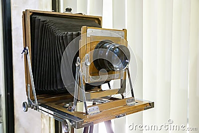 Very old rustic vintage large format camera as decoration in a room again white background. Side view Stock Photo