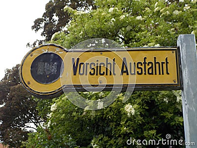 A very old sign warns of a garage exit. Editorial Stock Photo