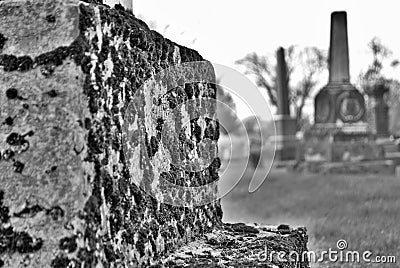 Very old statue and headstone in a cemetery Stock Photo