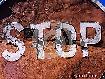 Very old STOP road sign with half-blown paint Stock Photo