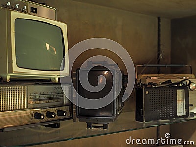 Old televisions and radios on a shelve Stock Photo