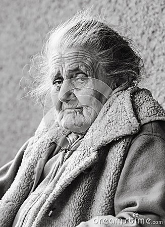 Very old and tired wrinkled woman outdoors Stock Photo