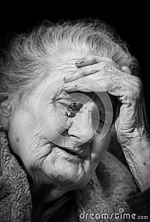 Very old and tired wrinkled woman outdoors Stock Photo