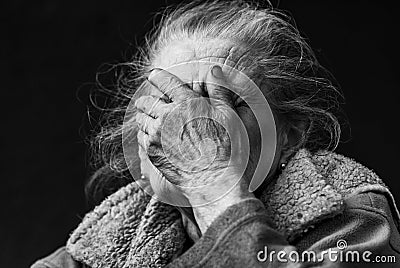 Very old and tired wrinkled woman outdoors Stock Photo