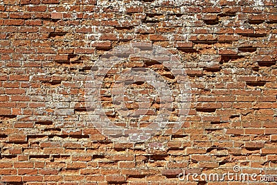 Very old weathered, damaged, badly repaired red brick wall Stock Photo